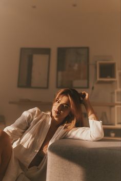 a woman sitting on top of a couch in a living room