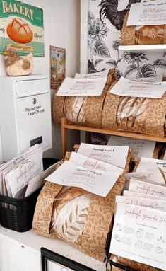 several bags of bread sitting on top of a counter next to a mailbox and file cabinet