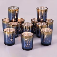 a group of blue glass cups with gold speckles