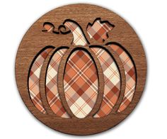 a wooden plaque with plaid pumpkins on the front and bottom, in an oval shape