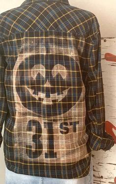 the back of a man's jacket with an image of a smiley face on it