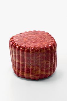 a red cake sitting on top of a white table