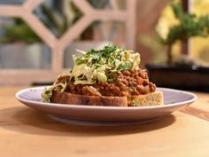 a close up of a plate of food on a table with a window in the background