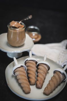 there are several desserts on the plate with spoons