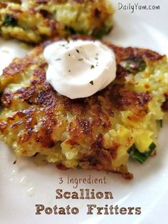 two crab cakes on a white plate with sour cream in the middle and spinach fritters