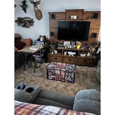 a living room filled with furniture and a flat screen tv mounted to the side of a wall