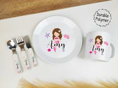 a plate, fork and spoon with the name anng on it next to two matching mugs