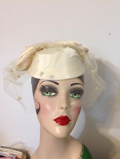 Beautiful Cream Colored Cap Style Hat.  Triple Bow at back and a short dotted veil.  New with no tags.  Inner circumference is 18 inches and height is 2 inches. Purchased at Hudson's, Detroit, in 1990.   Ideal for a wedding or special event.  It is Stunning  !! No shipping to Alaska, Hawaii, or International.    Shipping Fee is  $ 15.00 Fitted Cream Hat For Vintage Events, Fitted Cap Mini Hat For Wedding, Retro Adjustable Wedding Hats, Retro Fitted Cream Hat, Fitted Retro Cream Hat, Vintage Cream Mini Hat For Church, Vintage Wedding Mini Cap Hat, Retro Brimmed Wedding Hats, Fitted Vintage Bonnet For Wedding