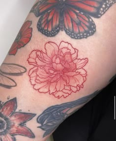 a close up of a person's arm with butterflies and flowers on the arm