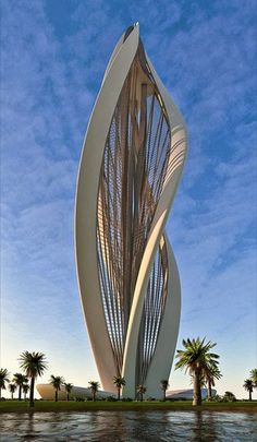 a tall white sculpture sitting on top of a lake next to palm trees and a blue sky