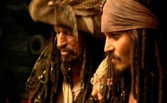 two men with dreadlocks on their heads and one wearing a bandana, the other in a pirate costume