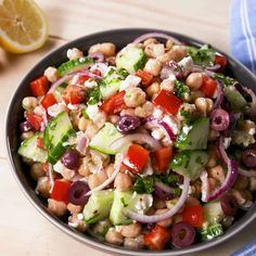 a salad with chickpeas, cucumbers, red onions and olives