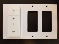 two switches and one light switch on a black surface