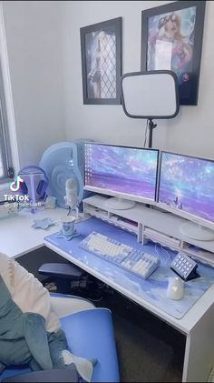 there is a desk with two computer monitors on it and a keyboard in front of the monitor