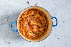 a blue pot filled with food on top of a table