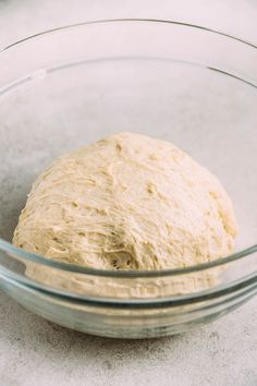 a ball of dough in a glass bowl