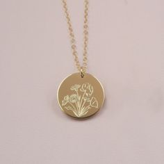 Our Wildflower necklace features a beautiful bouquet design engraved on the front, with the option to add a word, initials or a date on the back (or just keep it blank). Wildflowers are said to symbolize joy and the idea that life doesn't always have to grow according to plan to still be quite beautiful. Celebrate someone special in your life by gifting them this beautiful necklace and add a custom personalization on the back for the perfect touch. DETAILS: - 14kt gold filled or sterling silver Engraved Rose Gold Necklace With Flower Pendant, Rose Gold Engraved Flower Pendant Necklace, Anniversary Gift Birth Flower Necklace, Birth Flower Medallion Necklace For Anniversary, Dainty Birth Flower Jewelry For Anniversary Gift, Gold Botanical Necklace With Flower Charm, Gold Botanical Jewelry With Flower Charm, Yellow Gold Medallion Necklace With Birth Flower, Gold Floral Jewelry With Flower Charm