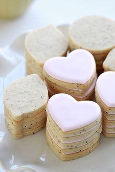 heart shaped cookies are arranged on a plate