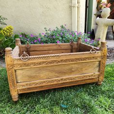 an old wooden planter sitting in the grass