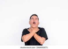 a man with his hands on his chest looking up at the sky and making a funny face