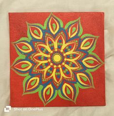 an orange and blue flower painted on canvas