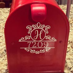 a red mailbox sitting on top of a counter