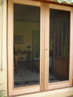 an open sliding glass door on the outside of a house