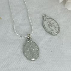 CORRINE - First Communion Necklace A pretty double sided First Communion Necklace of Sterling Silver The perfect gift for a young girl for her first communion. Delivered in a beautiful soft suede pouch to store and keep it safe. Like my facebook page to keep updated with new designs. www.facebook.com/keepsakepins Thank you for visiting :-) Miraculous Medal Round Pendant Necklace For Gift, Miraculous Medal Round Pendant Necklace As Gift, Silver Necklace With Miraculous Medal For Gift, Silver Necklace With Miraculous Medal As Gift, Dainty Silver Necklace With Miraculous Medal, Sterling Silver Miraculous Medal Necklace As Gift, Silver Necklace With Miraculous Medal For Jewelry Making, Oval Miraculous Medal Necklace As Gift, First Communion Gifts