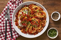 a white bowl filled with pasta and sauce