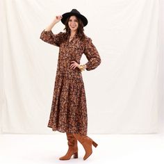 Add a splash of joy to your wardrobe with the Black Spice Madine Drop Waist Maxi Dress! Crafted from 100% cotton, this dress offers a delightfully comfortable fit that drapes beautifully. The vibrant pattern in warm spice tones is both eye-catching and stylish, perfect for making a statement. The full-length sleeves with elastic cuffs add a touch of charm and practicality, while the V-neck mandarin collar gives it an elegant touch. The dress features playful details like long decorative tassels Decorative Tassels, Beach Towel Gift, Cloth Cocktail Napkins, Eco Friendly Clothing, Drop Waist, Mandarin Collar, Tunic Dress, The Black, Scarf Accessory