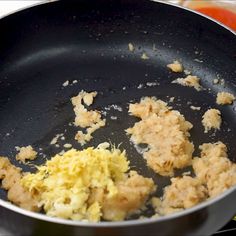 some food is being cooked in a frying pan on top of a stovetop