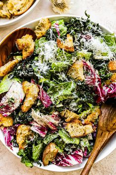 a salad with croutons and parmesan cheese