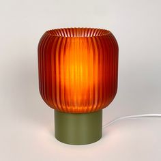 an orange lamp sitting on top of a table