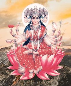 the hindu goddess sitting on top of a lotus flower in front of a sunset sky