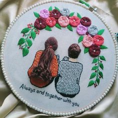 two people sitting together in front of a flowered circle with the words, always and together with you