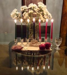 a table with candles and flowers on it