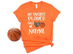 an orange tshirt with leopard print on it and a basketball next to it