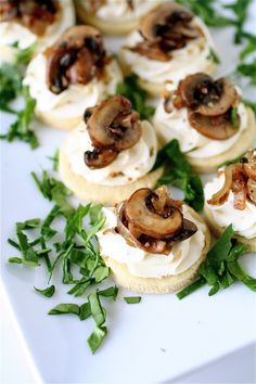 small sandwiches with mushrooms and greens on a white platter, ready to be eaten