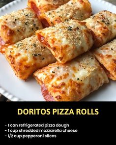 a white plate topped with pizza rolls covered in cheese