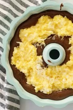 a chocolate bundt cake with an eyeball on top and the words coconut filled chocolate bundt cake recipe above it