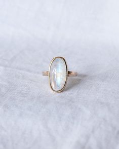 Extraordinary Moonstone Gold Ring 9ct Ring Size: O estimate  Weight: 4.6g estimate Please note that all of our stones are natural stones and have natural inclusions/ flaws as you can see in the photos.  Stone: Moonstone  Moonstone is a mineral of the orthoclase feldspar group and is composed of potassium aluminum silicate. It is distinguished from other similar stones by the presence of adularescence. Though the stone has optical qualities similar to some labradorite stones, labradorite is a pla Fine Jewelry 14k Gold Cabochon Moonstone Ring, 14k Gold Fine Jewelry Moonstone Cabochon Ring, 14k Gold Cabochon Moonstone Ring, Celestial Opal Birthstone Ring In Oval Shape, Celestial Oval Opal Birthstone Ring, 14k Gold Moonstone Cabochon Ring For Anniversary, Hallmarked Yellow Gold Moonstone Ring, Celestial Oval Cabochon Rings, Yellow Gold Moonstone Gemstone Rings