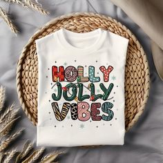 a white t - shirt with the words holly jolly be merry on it