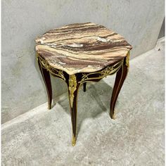 a marble topped table sitting on top of a floor