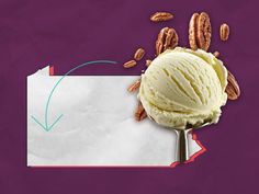 a scoop of ice cream with pecans around it on top of a piece of paper