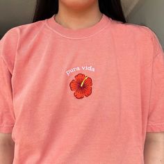 🌺 "Pura Vida" embroidered on a comfy retro style tee. Wear it to show your love for Costa Rica, reminisce about a memorable vacation, or simply add a touch of tropical flair to your ensemble. *SIZES ARE UNISEX* -I'd suggest your usual size for a more fitted look, or sizing up for a more relaxed fit. Model is 5'3, wearing color "seafoam" in size Large * 100% ring-spun cotton * Fabric weight: 6.1 oz/yd² (206.8 g/m²) * Garment-dyed * Relaxed fit * 7/8″ double-needle topstitched collar * Twill-taped neck and shoulders for extra durability * Double-needle armhole, sleeve, and bottom hems Please note that the embroidery comes with a backing that acts as a stabilizer to support the fabric and stitches. We do not accept returns or exchanges, but please message me if anything is wrong with your or Pink Embroidered Casual T-shirt, Casual Red Embroidered T-shirt, Summer Pink T-shirt With Floral Embroidery, Casual Red T-shirt With Floral Embroidery, Casual Floral Embroidered Tops For Streetwear, Oversized Summer Shirt, Vacation Aesthetic, Wearing Color, Beach Tee