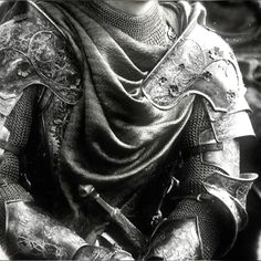 a black and white photo of a man in armor