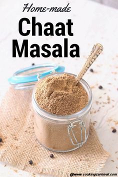 homemade chaat masala in a small glass jar with a wooden spoon on top