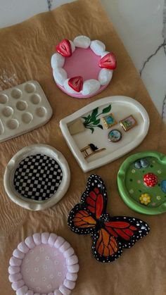 there are many different types of toys on the table together, including plastic plates and trays