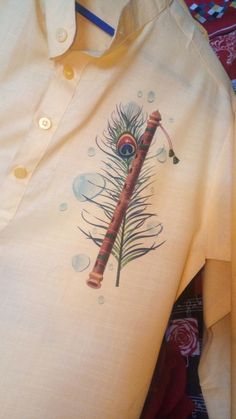 a white shirt with an image of a feather on it