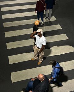 several people walking across a crosswalk in the city